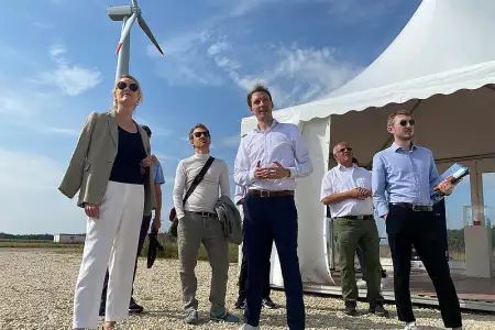 Minister Walker and other people on the crane pad of a wind turbine.