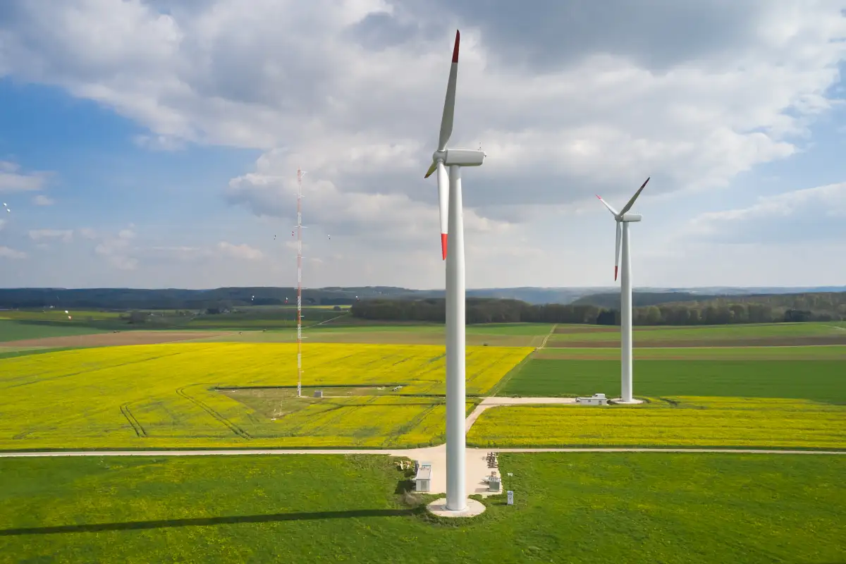 Side view of two wind turbines and a met mast